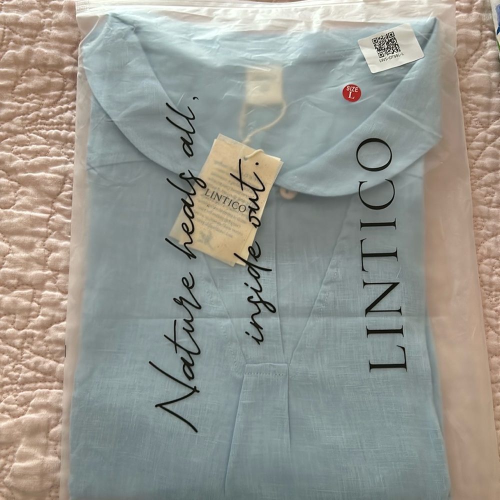 Light blue linen blouse. In original bag with tags.